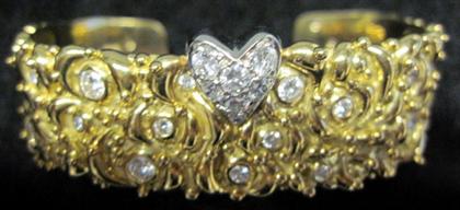 Appraisal: karat yellow gold and diamond cuff braceletHigh relief swirl detailing