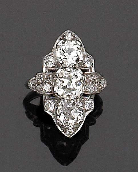 Appraisal: centering three old mine-cut diamonds accented by transitional round brilliant