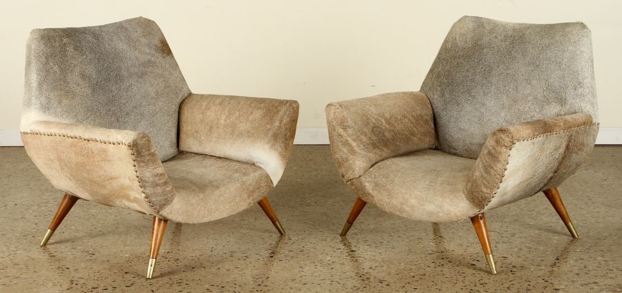 Appraisal: PAIR COWHIDE UPHOLSTERED CLUB CHAIRS CIRCA A pair of mid