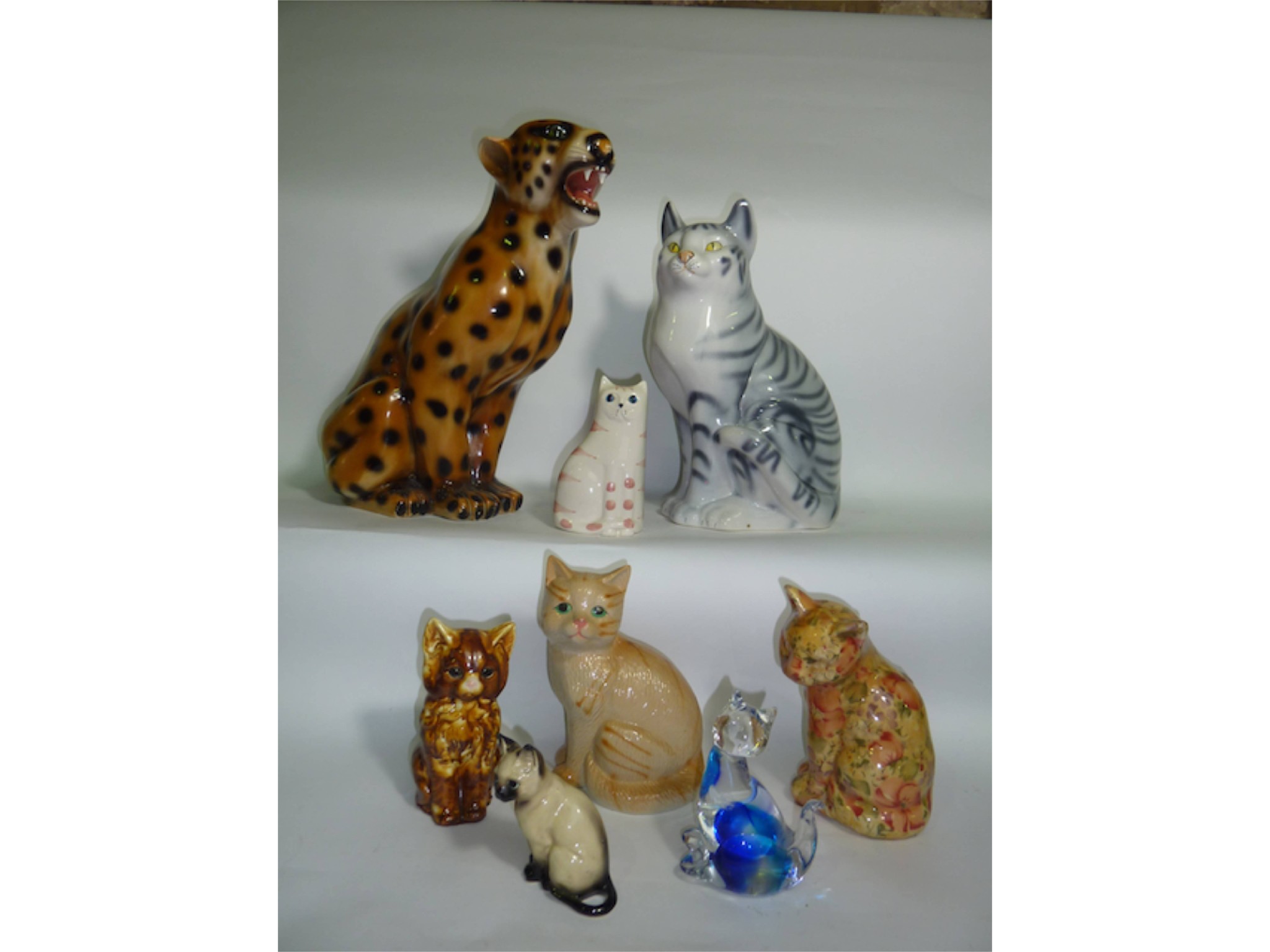 Appraisal: A collection of ceramic and glass model cats including two