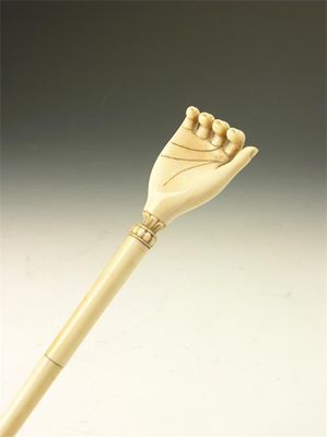 Appraisal: A th century carved ivory back scratcher modelled as a