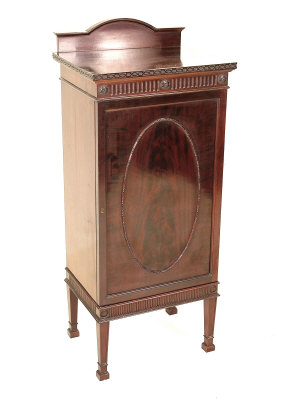 Appraisal: An Edwardian flame mahogany music cabinet the raised arched back