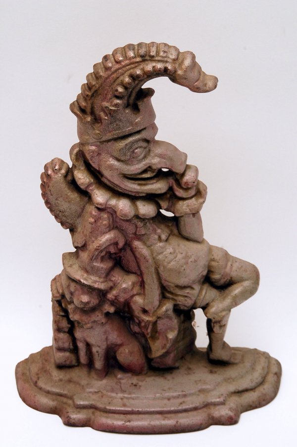 Appraisal: Painted cast iron doorstop of seated jester with dog unmarked