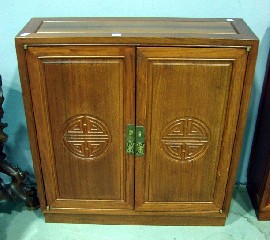 Appraisal: A Chinese low side cabinet in rosewood fitted with a