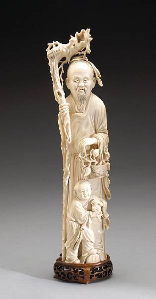 Appraisal: A carved and tinted ivory figure of a Daoist immortal