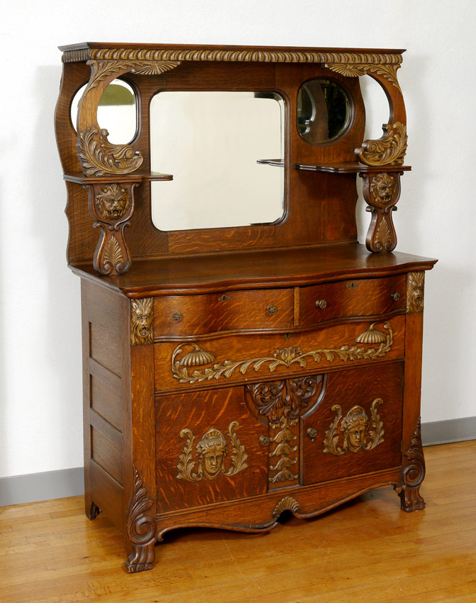 Appraisal: CARVED AMERICAN GOLDEN OAK SIDEBOARD Carved decoration to include figural