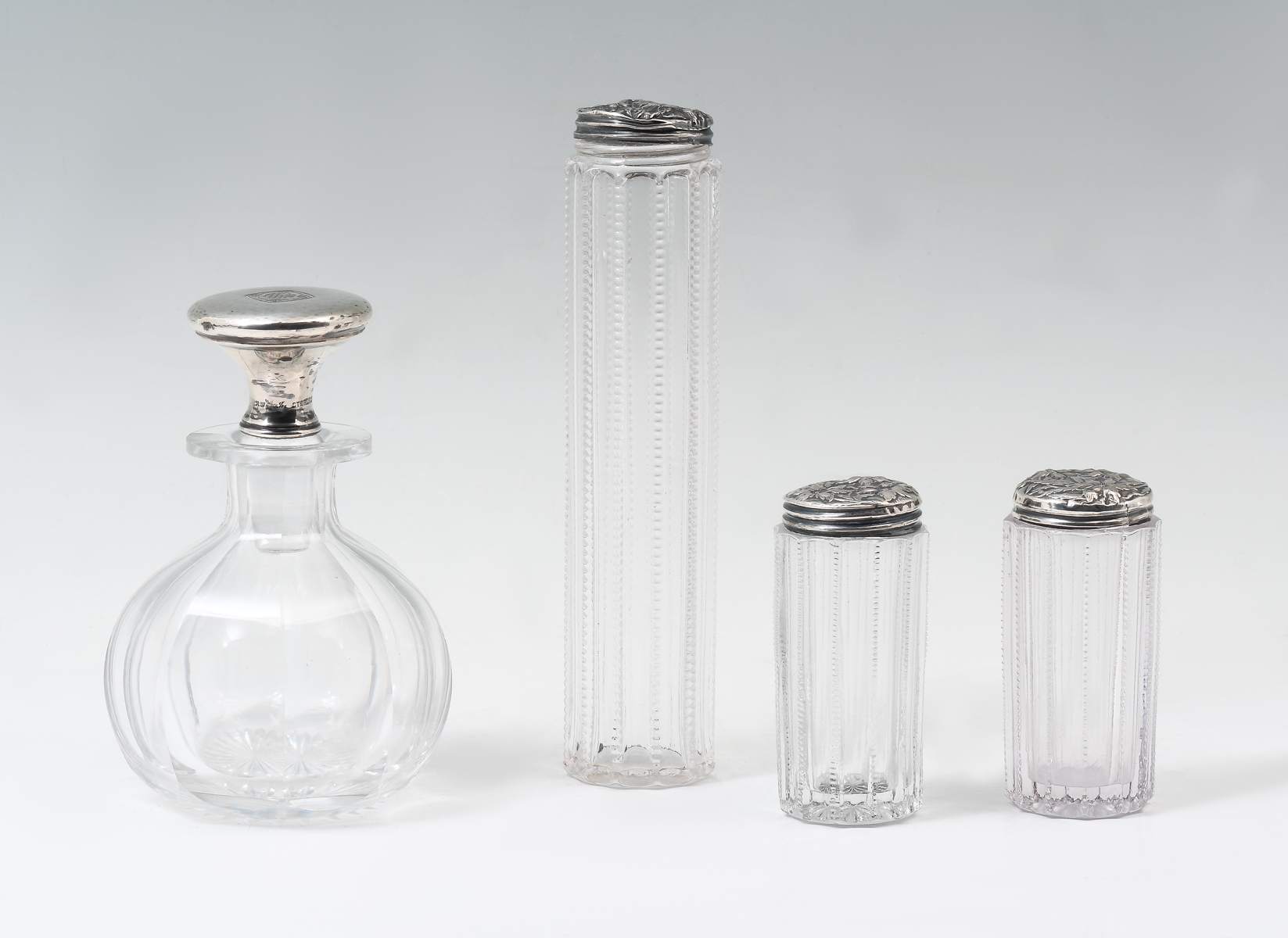 Appraisal: CUT GLASS VANITY BOTTLES WITH STERLING glass crystal dresser bottles