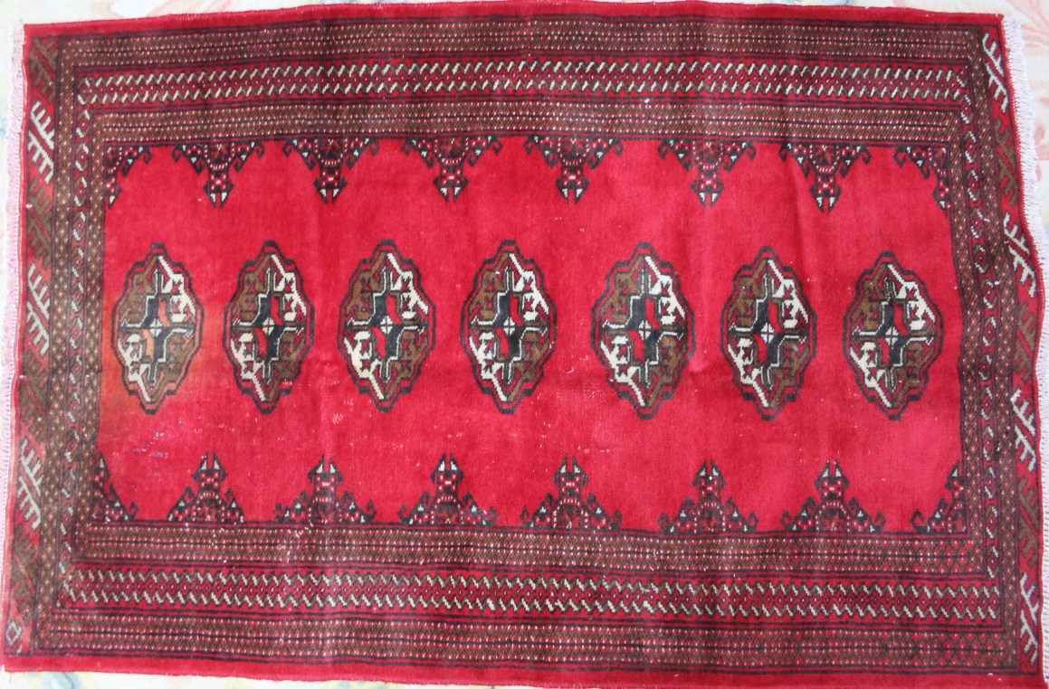 Appraisal: A Torkaman rug in medallion style repeated in red cm