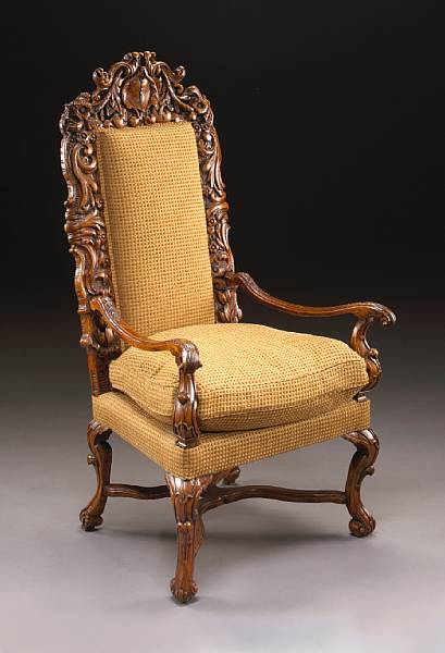 Appraisal: A Spanish Baroque carved walnut armchair The upholstered panel back