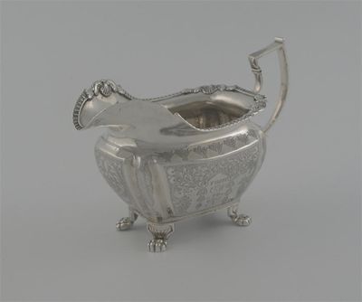 Appraisal: A George IV Irish cream jug with engraved foliate design