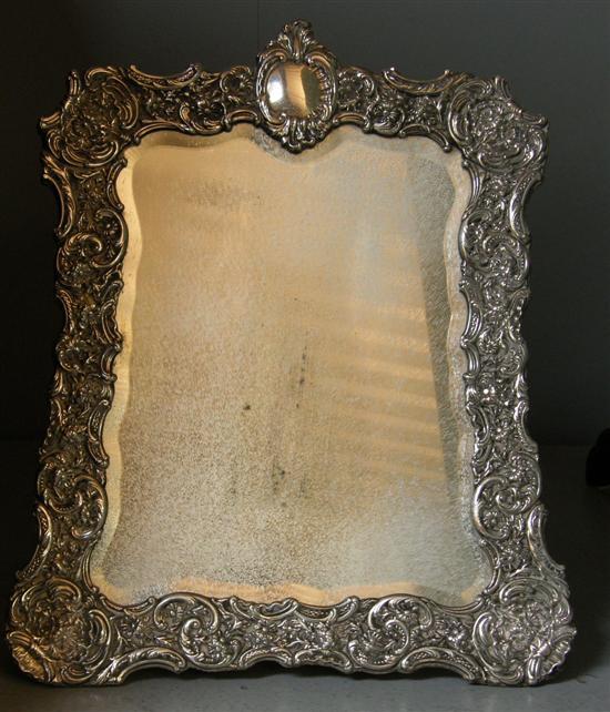 Appraisal: Silver framed strut mirror with embossed floral decoration x London