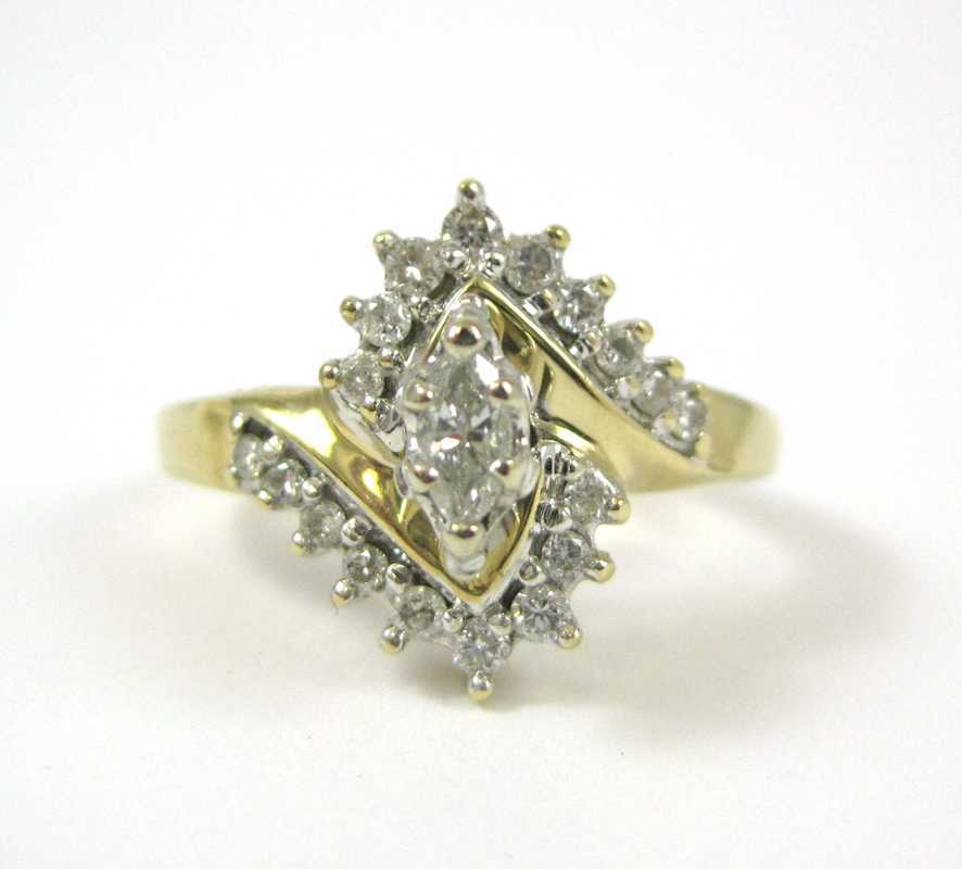 Appraisal: DIAMOND AND FOURTEEN KARAT GOLD RING eighteen round-cut diamonds surround