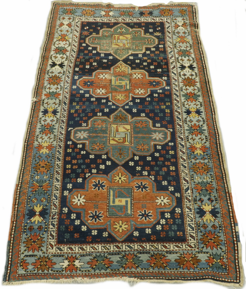 Appraisal: KAZAK RUG Column of four 'cruciform' medallions in blue-green brick