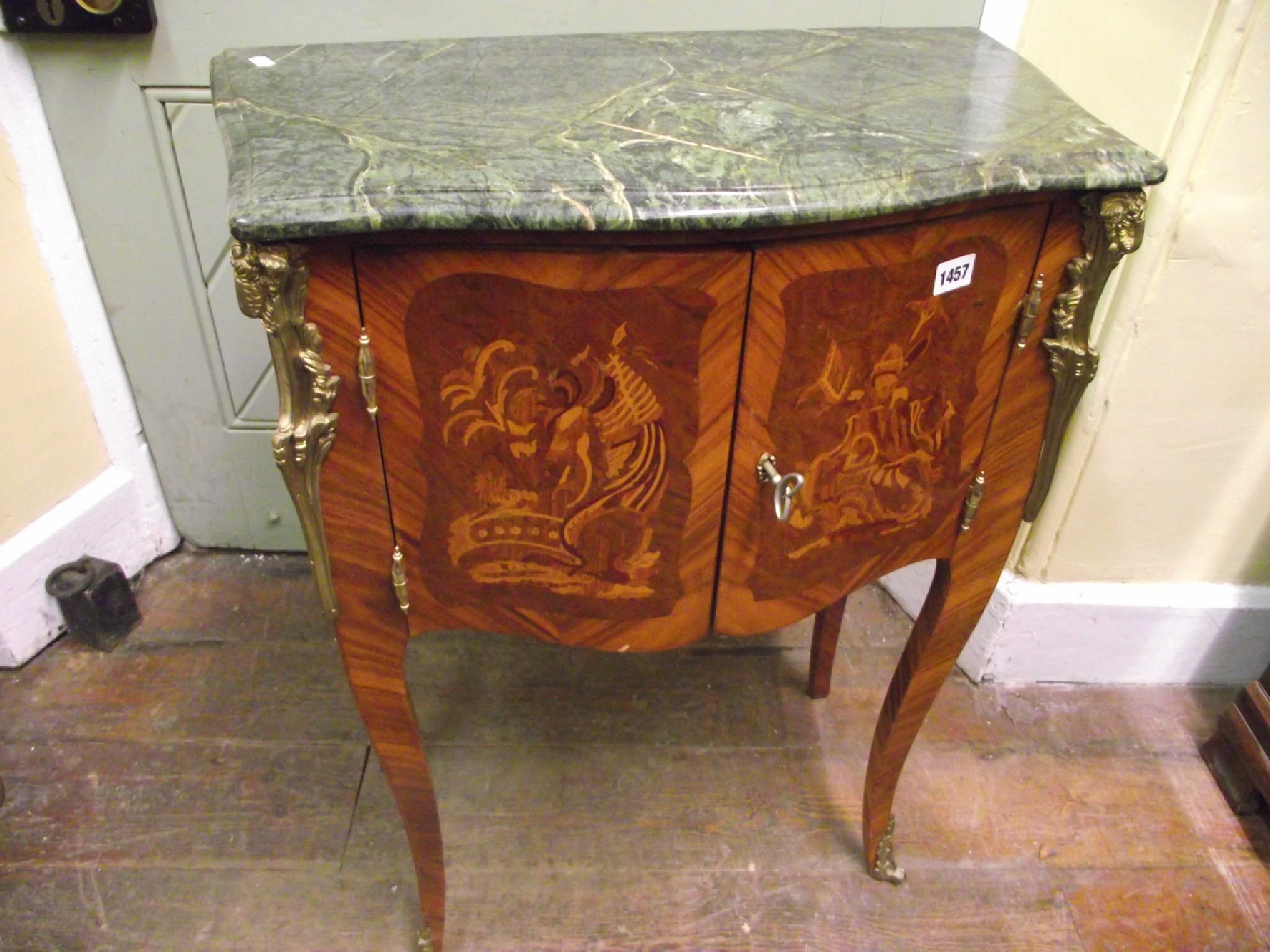 Appraisal: A French influence walnut and marquetry inlaid serpentine side cabinet