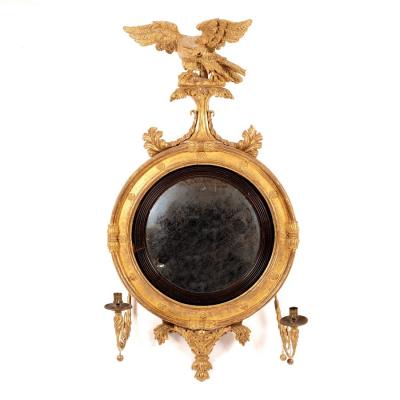 Appraisal: A Regency convex mirror in gilt frame with eagle surmount