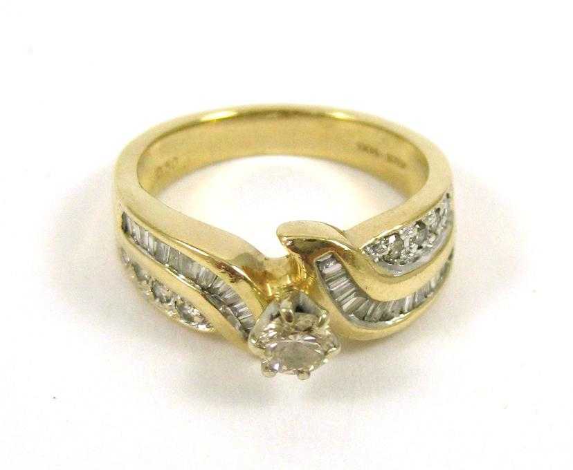 Appraisal: DIAMOND AND FOURTEEN KARAT GOLD RING with round-cut and tapered