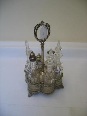 Appraisal: A VICTORIAN SIX BOTTLE CRUET of flori form with central