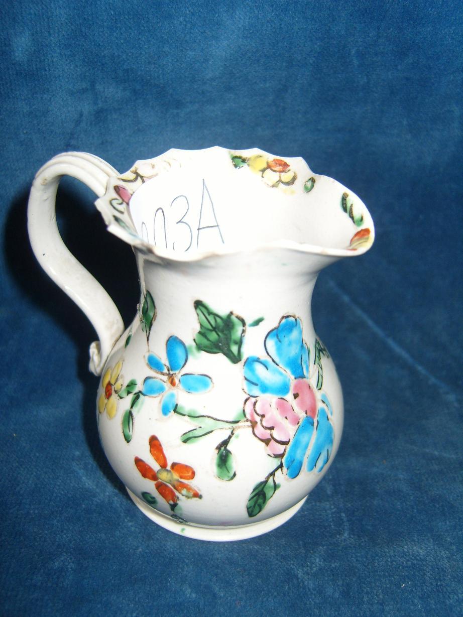 Appraisal: An th century jug with shaped rim polychrome painted floral