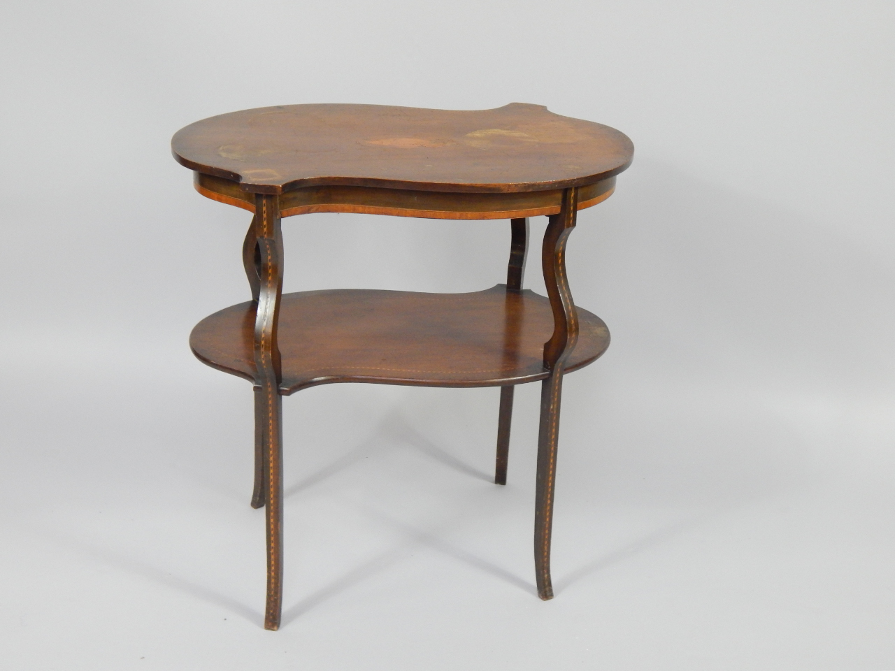 Appraisal: A Victorian mahogany and satinwood crossbanded two tier kidney shaped