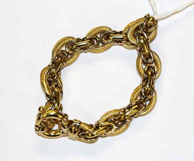 Appraisal: A CONTEMPORARY GOLD BRACELET with hollow links and twisted decoration