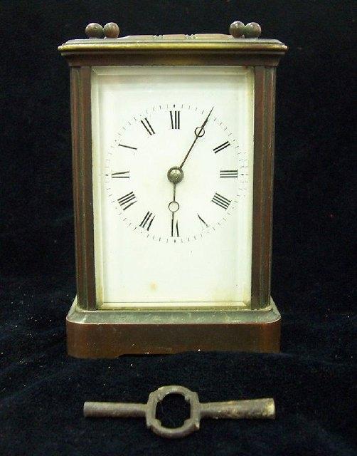 Appraisal: A gilt brass carriage clock with white rectangular face the