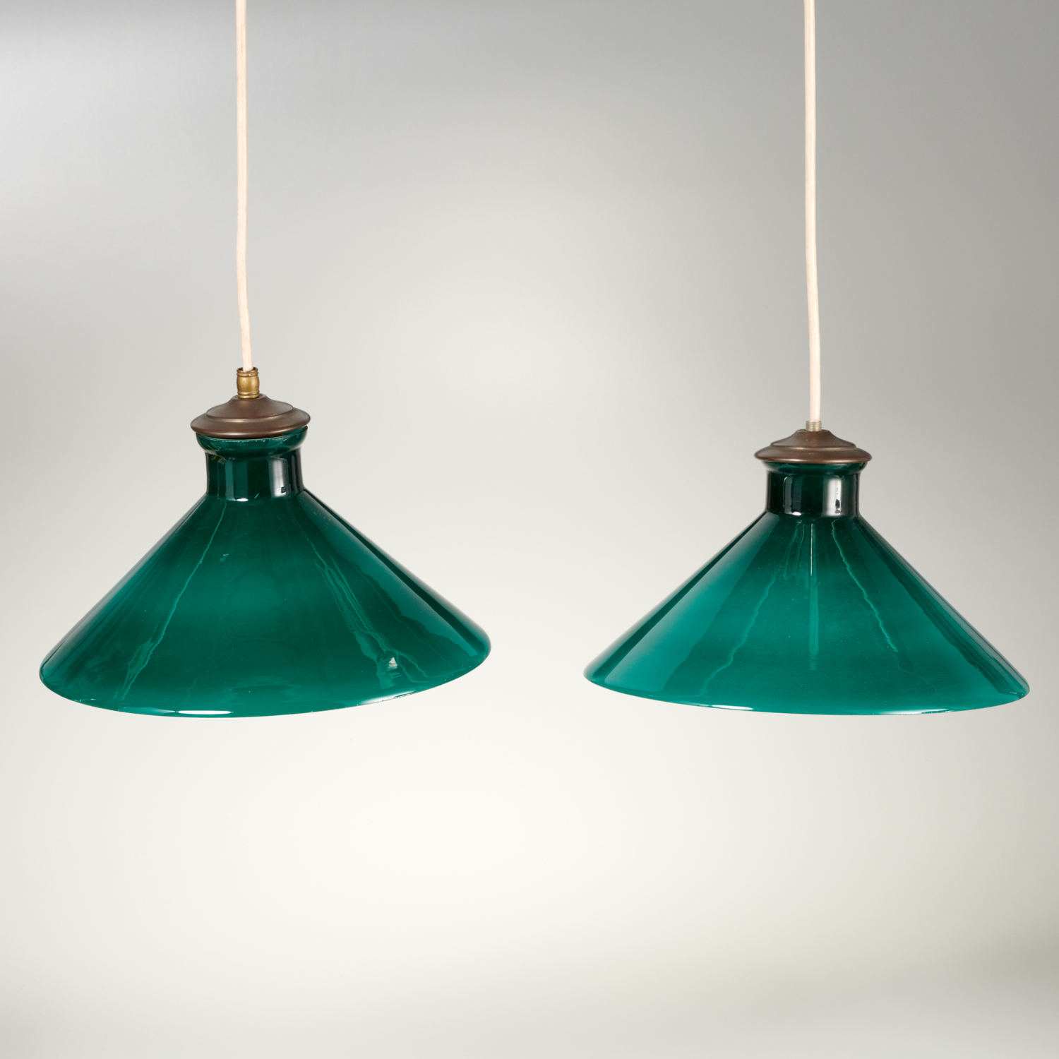 Appraisal: PAIR VINTAGE CONICAL GREEN GLASS PENDANT LIGHTS th c shades