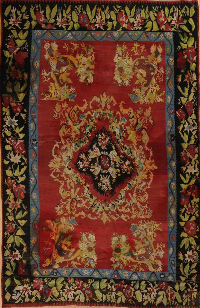 Appraisal: ROSE-GROUND FLATWEAVE CARPET Worked with black quatrefoil medallion within foliate