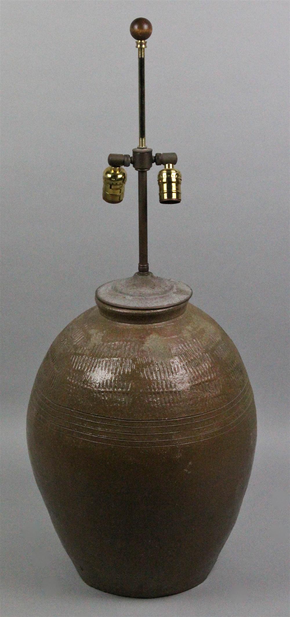 Appraisal: ASIAN BROWN-GLAZED AND MOLDED STORAGE JAR NOW MOUNTED AS A