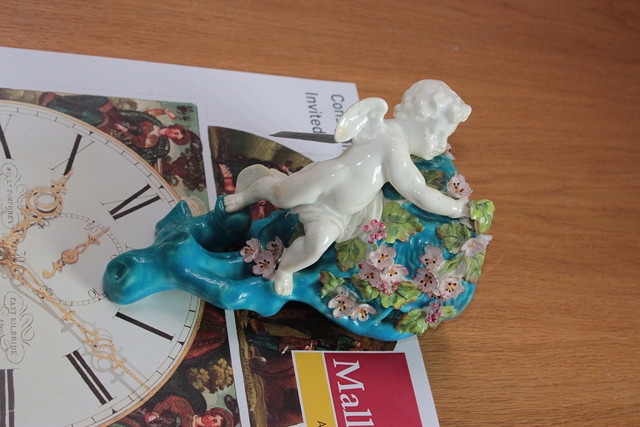 Appraisal: A VICTORIAN PORCELAIN WALL POCKET naturistically moulded with a cherub