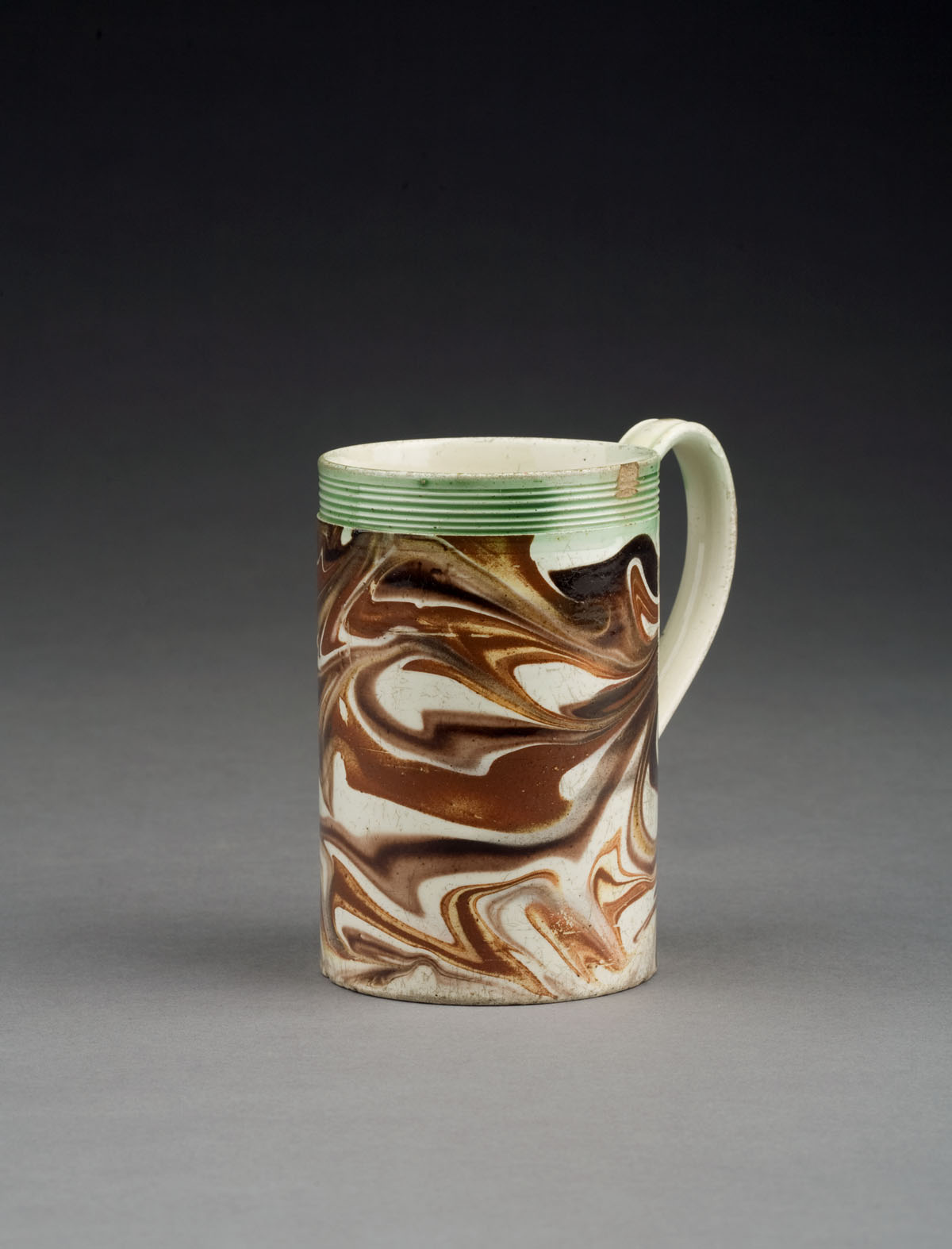 Appraisal: BRITISH CREAMWARE MOCHAWARE MUG CIRCA - Slip-marbled in shades of