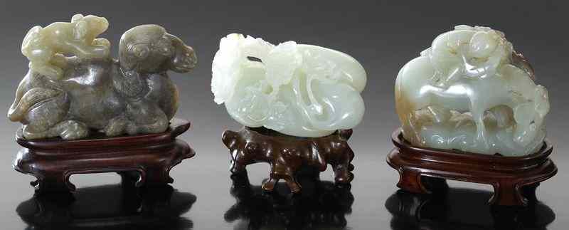 Appraisal: Chinese carved jade figuresdepicting camels horses sheep a boy and