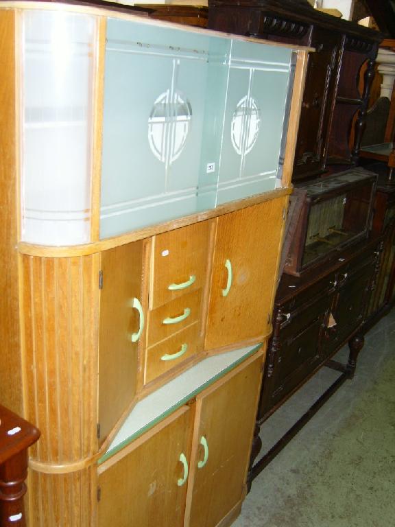 Appraisal: A light oak kitchen Queen cabinet the upper section enclosed