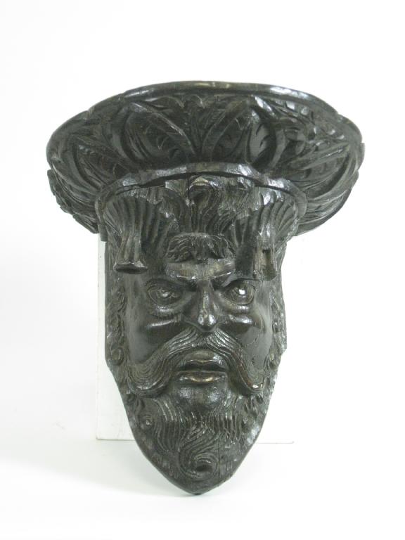 Appraisal: A th Century carved oak Head of Neptune beneath egg