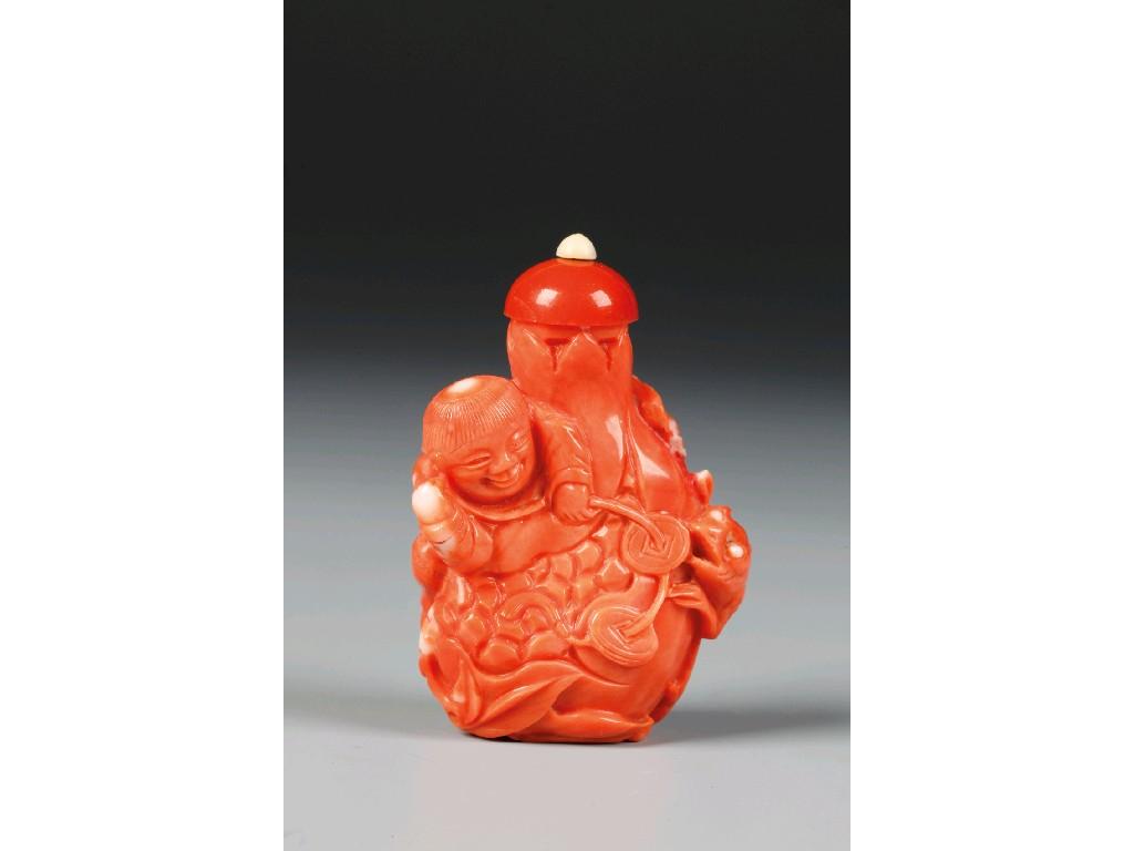 Appraisal: A CHINESE CORAL SNUFF BOTTLE carved as a playful boy