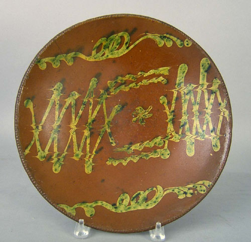 Appraisal: Redware charger th c with yellow and green slip decoration