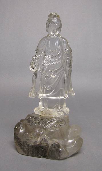 Appraisal: A rock crystal figure of Guanyin standing on a rock