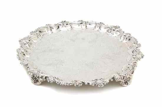 Appraisal: An English Silverplate Footed Salver with scalloped borders raised on