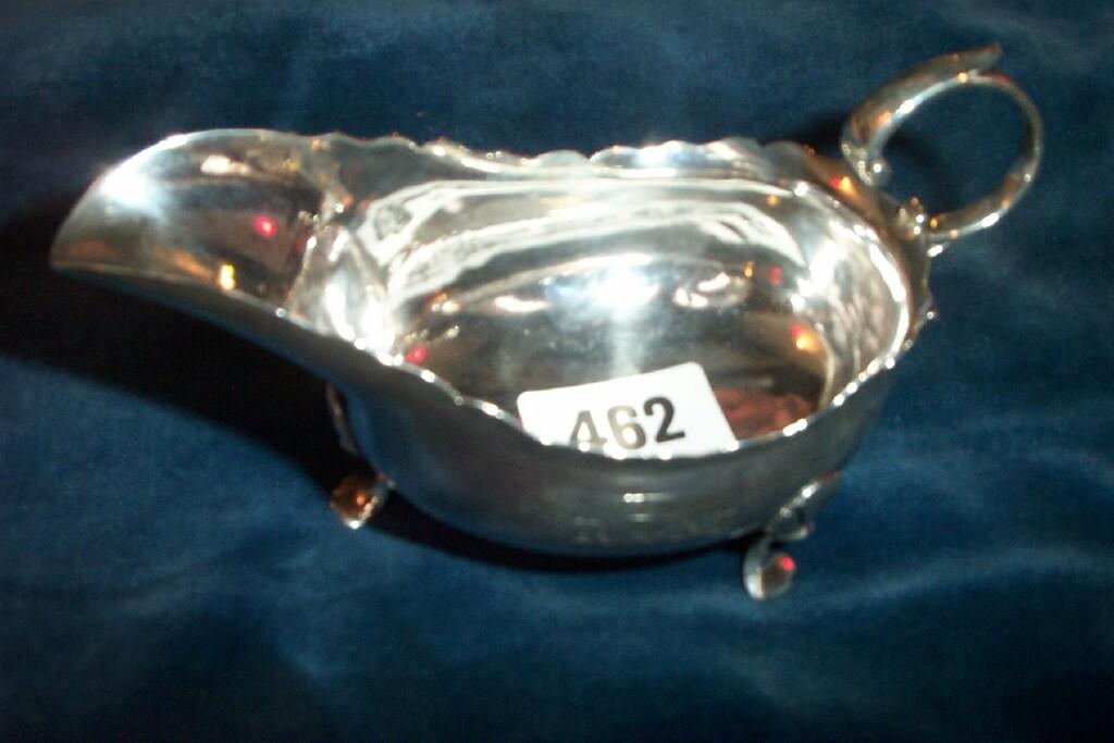 Appraisal: An th century silver sauce boat flying loop handle cabriole