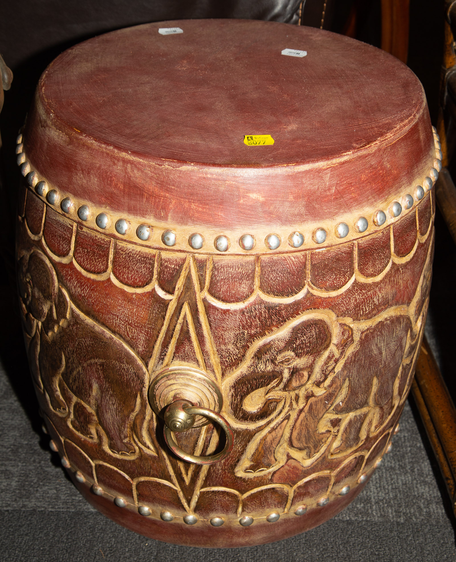 Appraisal: INDIAN CARVED WOOD RAWHIDE DRUM th century with elephants carved