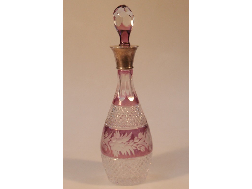 Appraisal: A purple tinted cut glass decanter with silver collar modern