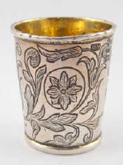 Appraisal: A Russian silver vodka tot with chased decoration including the