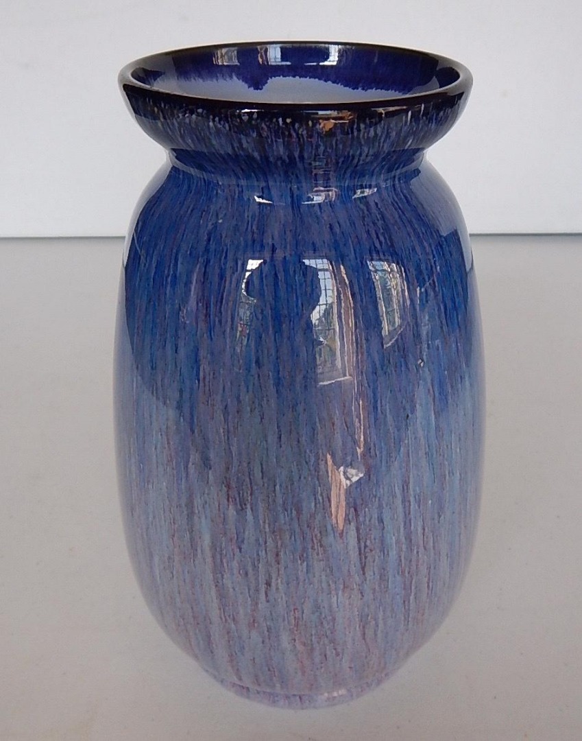 Appraisal: A stoneware ovoid vase with flared rim and running blue