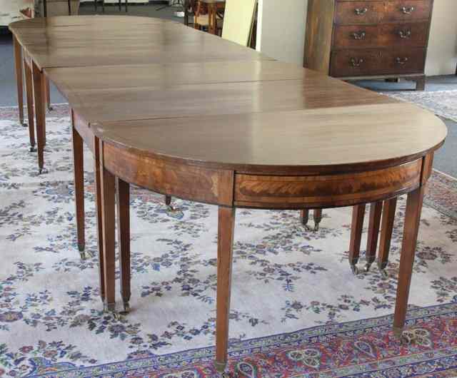 Appraisal: A mahogany dining table the whole with ebonised stringing comprising