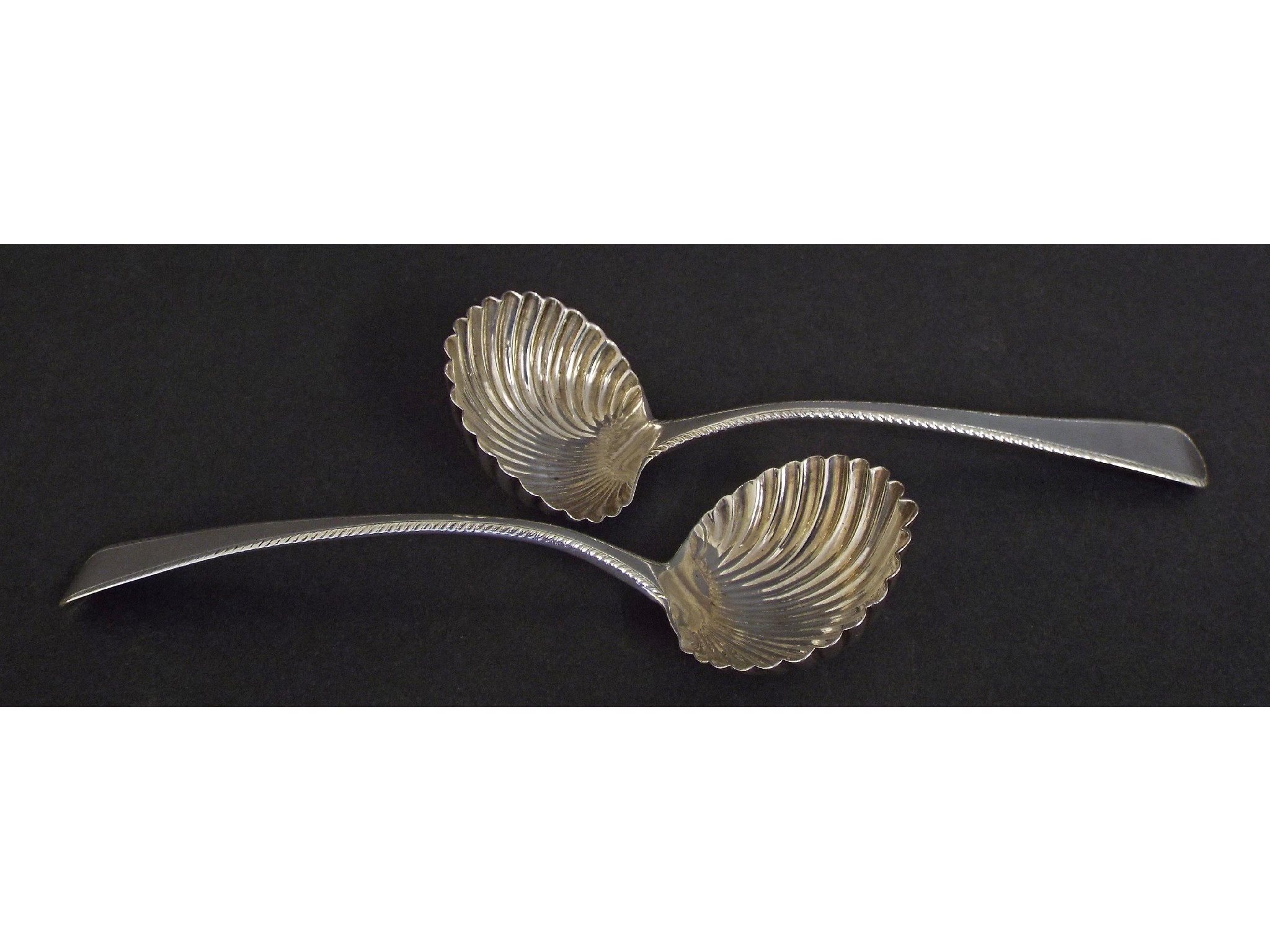 Appraisal: Pair of Regency silver sauce ladles with scallop shell bowls