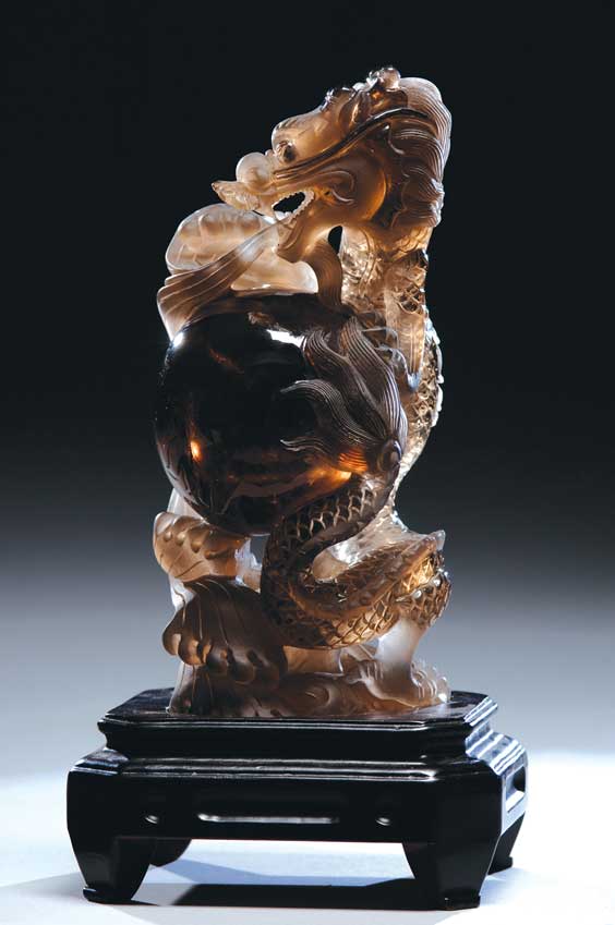 Appraisal: QUARTZ CRYSTAL DRAGON AND SPHERE Well carved Chinese dark smokey