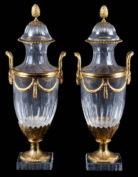 Appraisal: A pair of gilt bronze mounted glass covered urns the