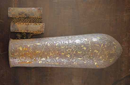 Appraisal: An Islamic gold inset iron arm guard decorated with huntsmen