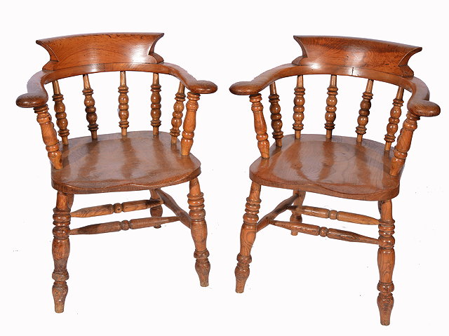 Appraisal: A PAIR OF ASH AND ELM CAPTAINS CHAIRS with curving