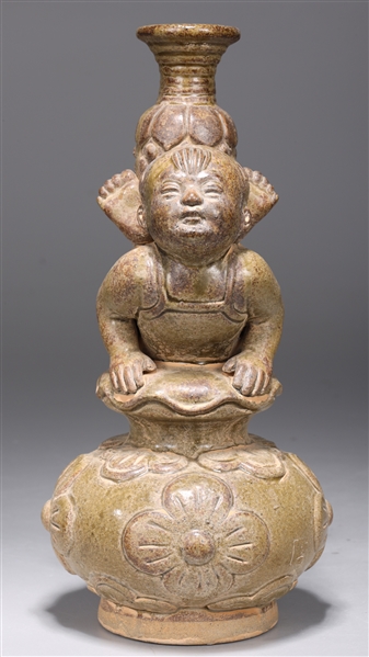 Appraisal: Unique Chinese molded and parcel-glazed pottery figural candlestick of baby