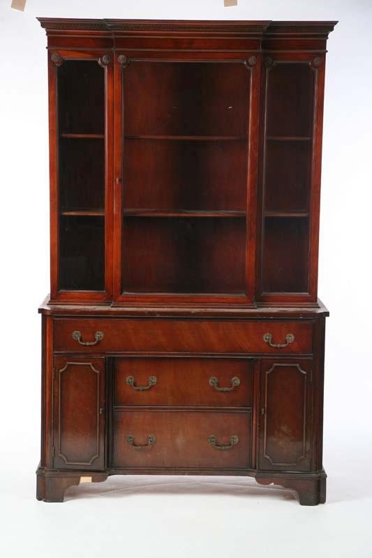 Appraisal: BREAKFRONT CABINET Mahogany with a geometric carved cornice glazed door